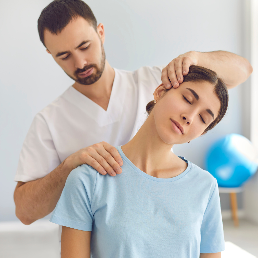 A man is giving a woman a neck massage.