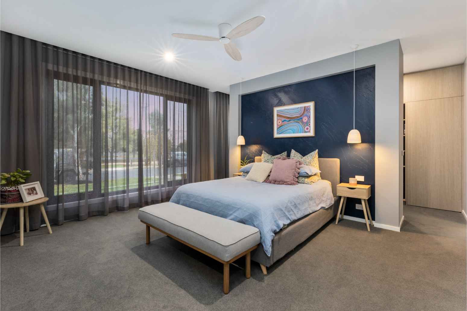 A Bedroom With A Large Bed And A Ceiling Fan — Jetsonian Constructions In Wendouree, VIC