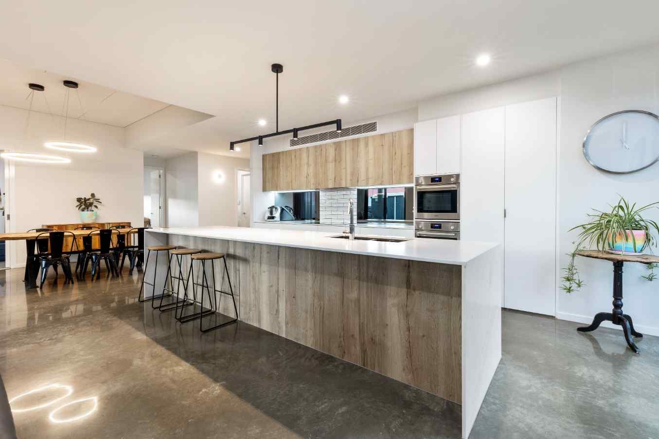 A Kitchen With A Large Island And A Clock On The Wall — Jetsonian Constructions In Wendouree, VIC