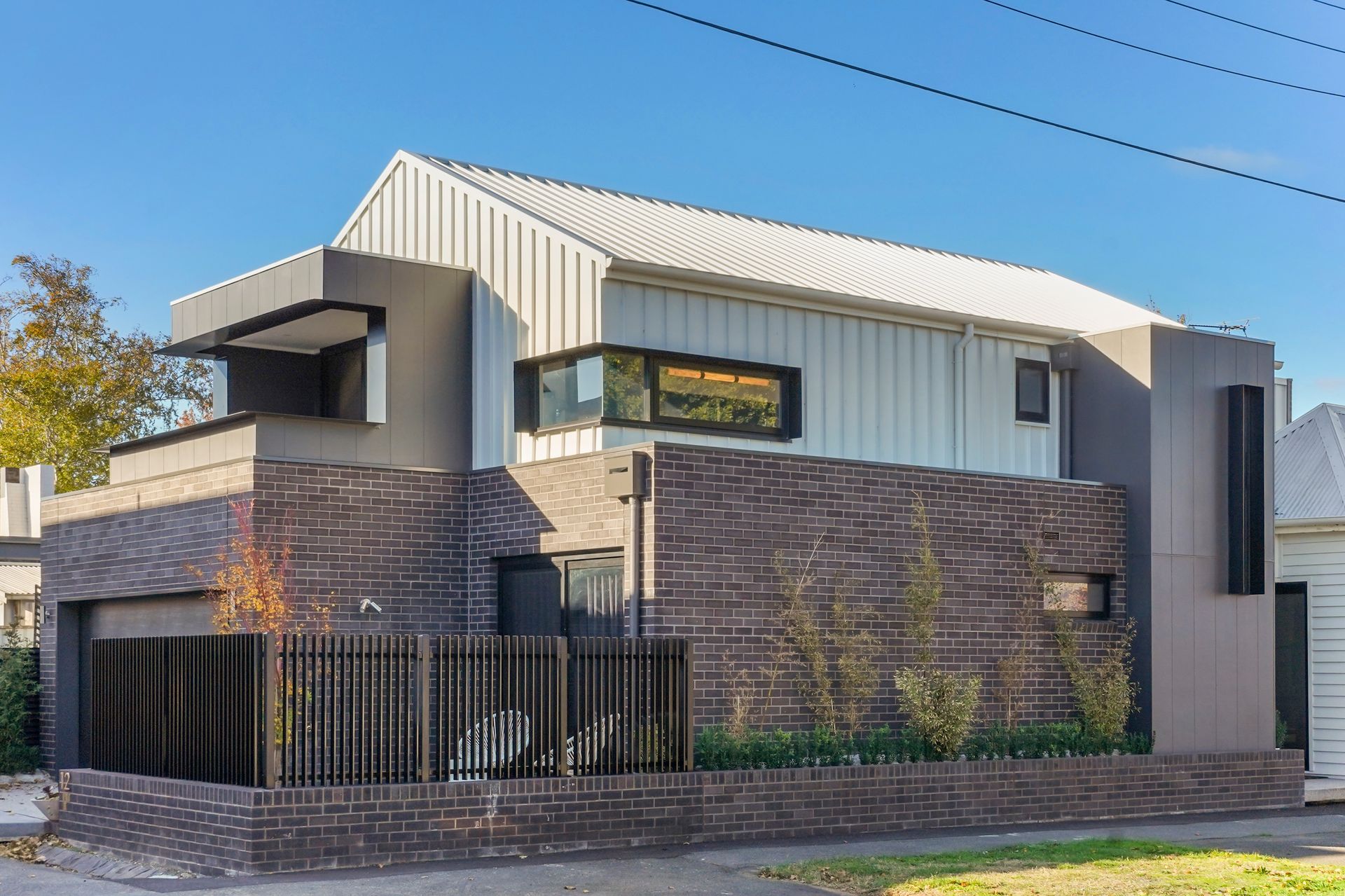 A large modern house with a white roof and a brick wall — Jetsonian Constructions In Wendouree, VIC