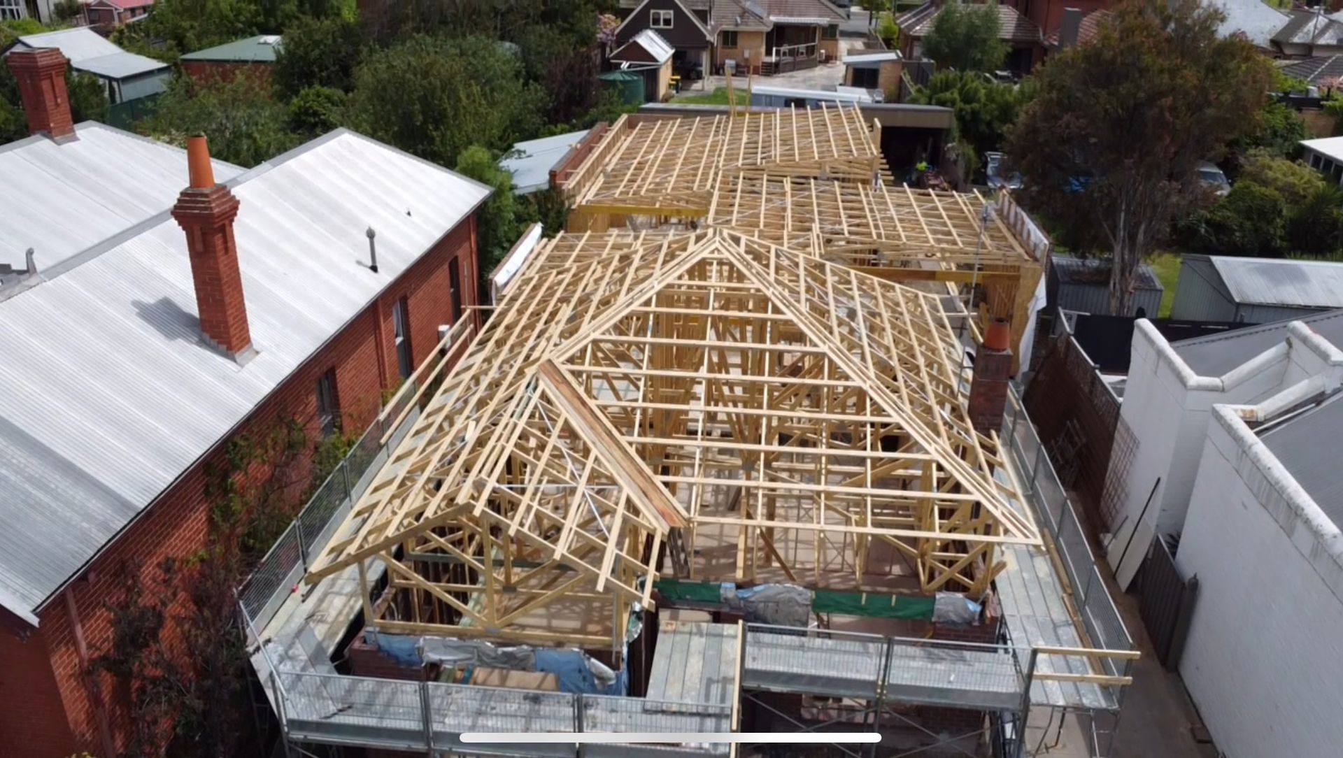 Aerial View of a House Roof Under Construction With Exposed Wooden Trusses in a Residential Neighborhood — Jetsonian Constructions In Wendouree, VIC