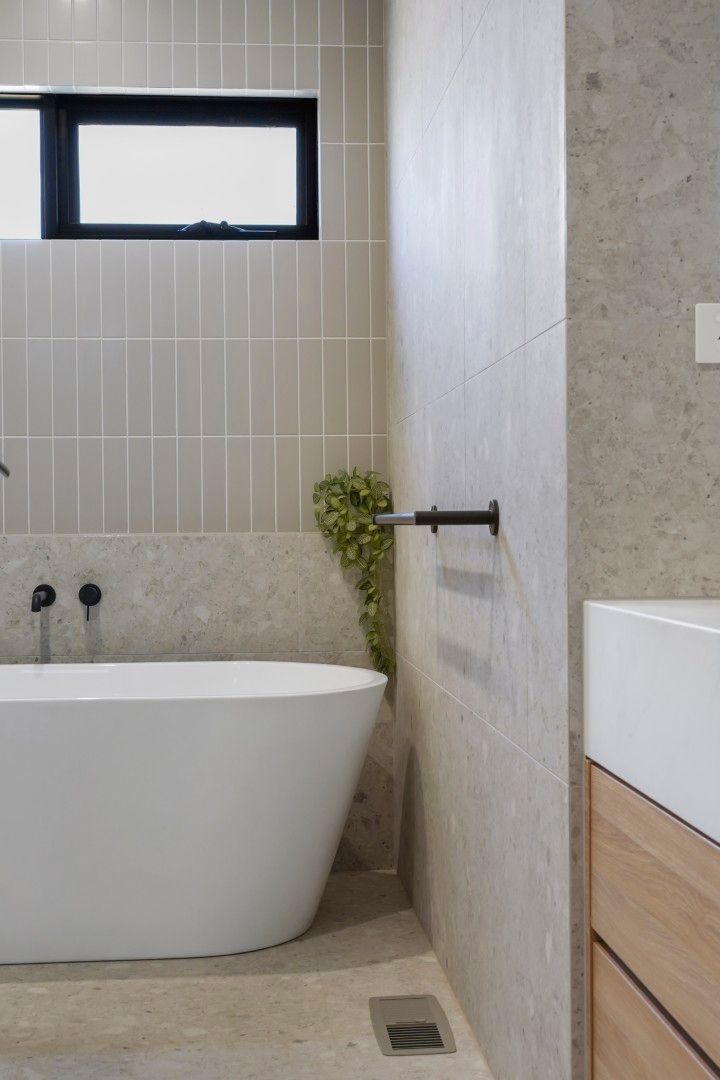 Modern Bathroom With Freestanding Tub, Window, Towel Bar, and Wooden Vanity — Jetsonian Constructions In Wendouree, VIC