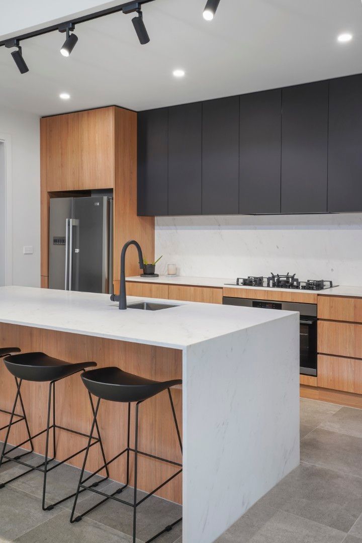 Modern Kitchen With White Island, Black Stools, Wood Cabinets, and Dark Upper Cabinets — Jetsonian Constructions In Wendouree, VIC
