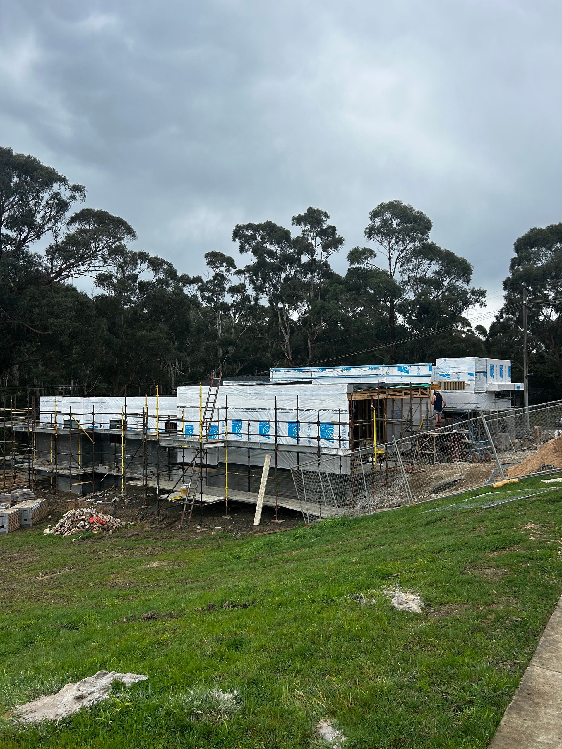 Rundown Stone Building Under Construction on a Grassy Hillside Beneath a Cloudy Sky — Jetsonian Constructions In Wendouree, VIC