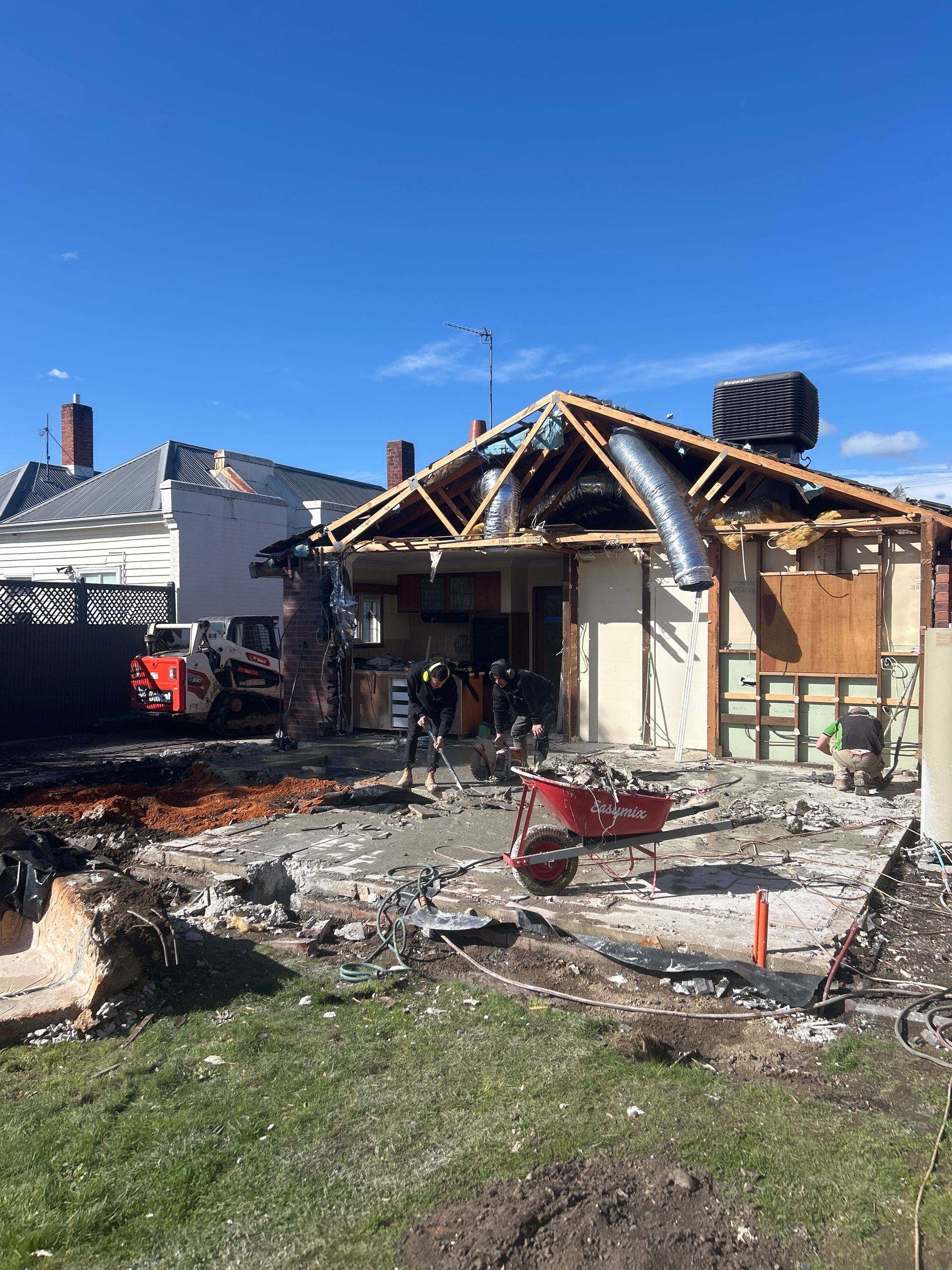 Burned House With Collapsed Roof and Debris in a Residential Yard Under a Clear Blue Sky — Jetsonian Constructions In Wendouree, VIC