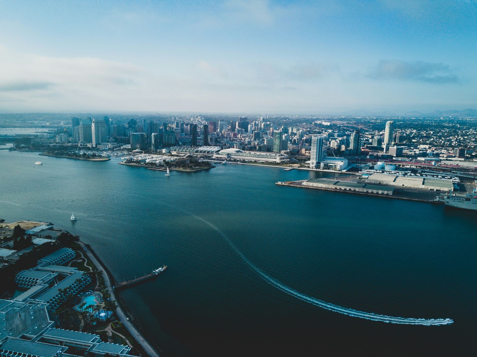 An aerial view of a large body of water with a city in the background