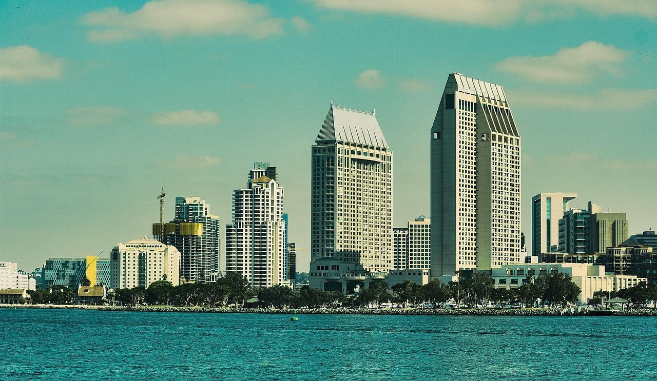 A city skyline with a body of water in the foreground