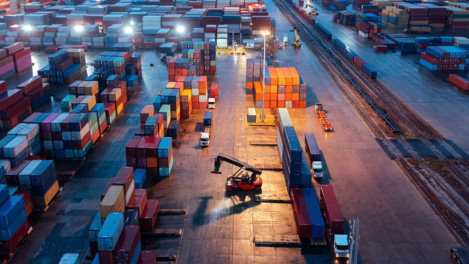 Aerial view forklift handling containers.