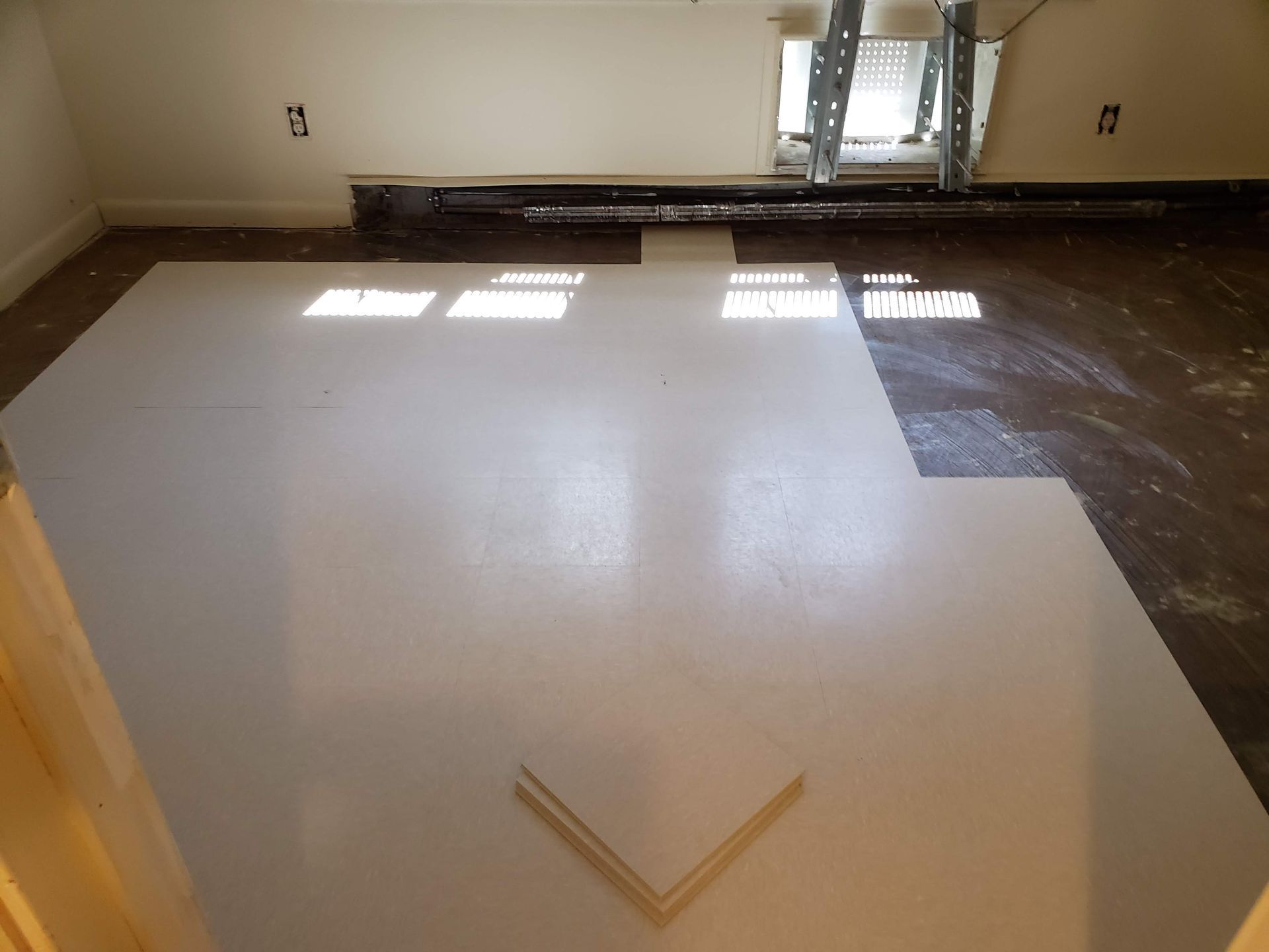 A room that is being remodeled with a ladder in the background