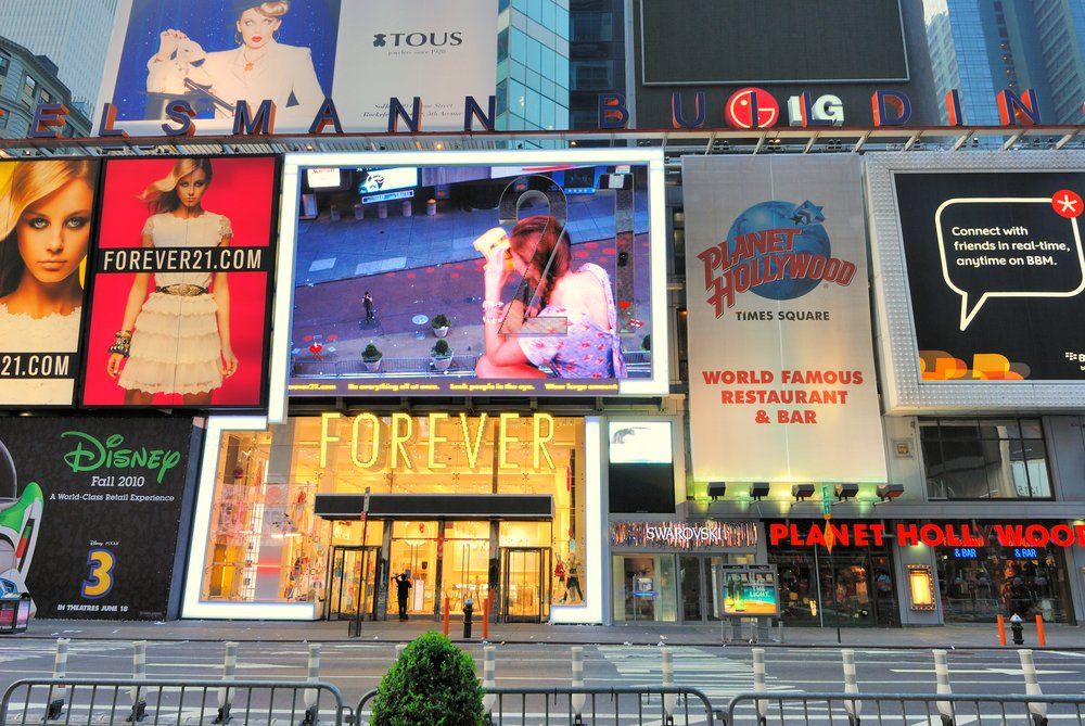 A busy city street with a sign that says forever