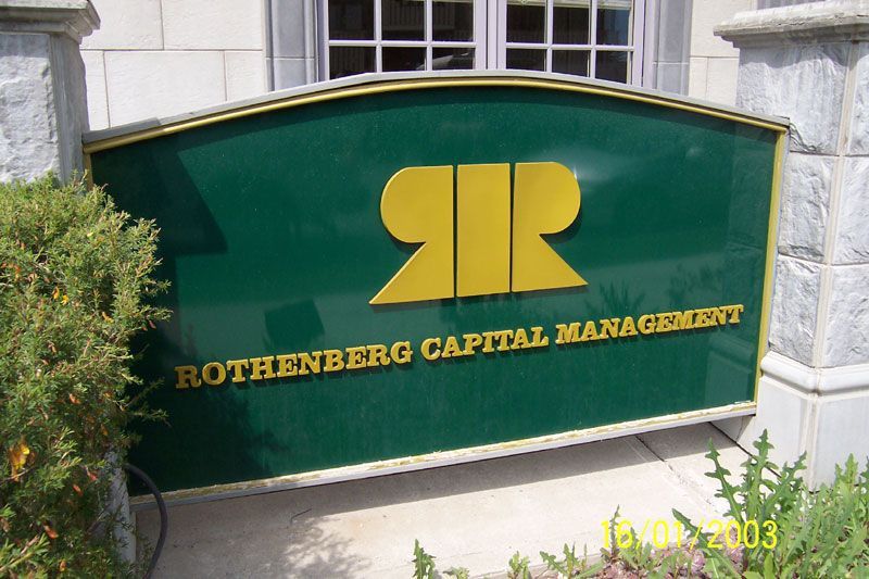 Sign for Rothenberg Capital Management, green with yellow logo and text.