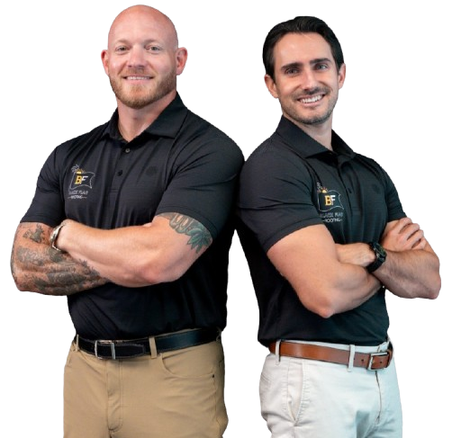Two men in black polos pose with arms crossed against a white background.