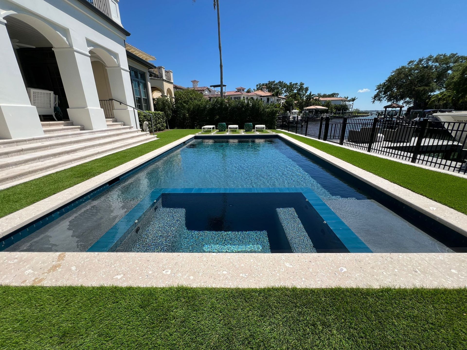 A large swimming pool in the backyard of a house