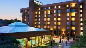 DoubleTree by Hilton hotel exterior, evening shot with pool and lights.