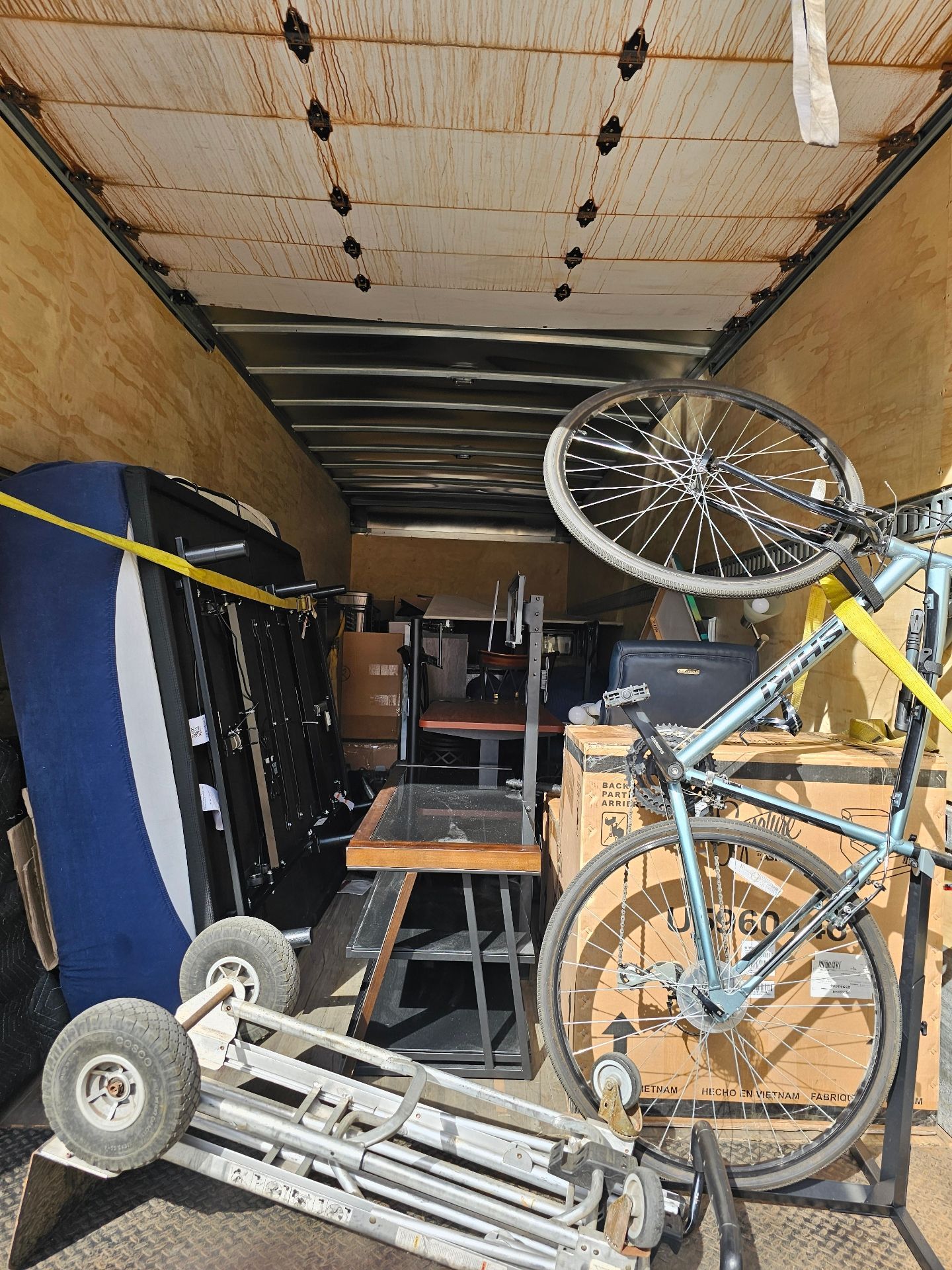 A bicycle is sitting on top of a table in a trailer.