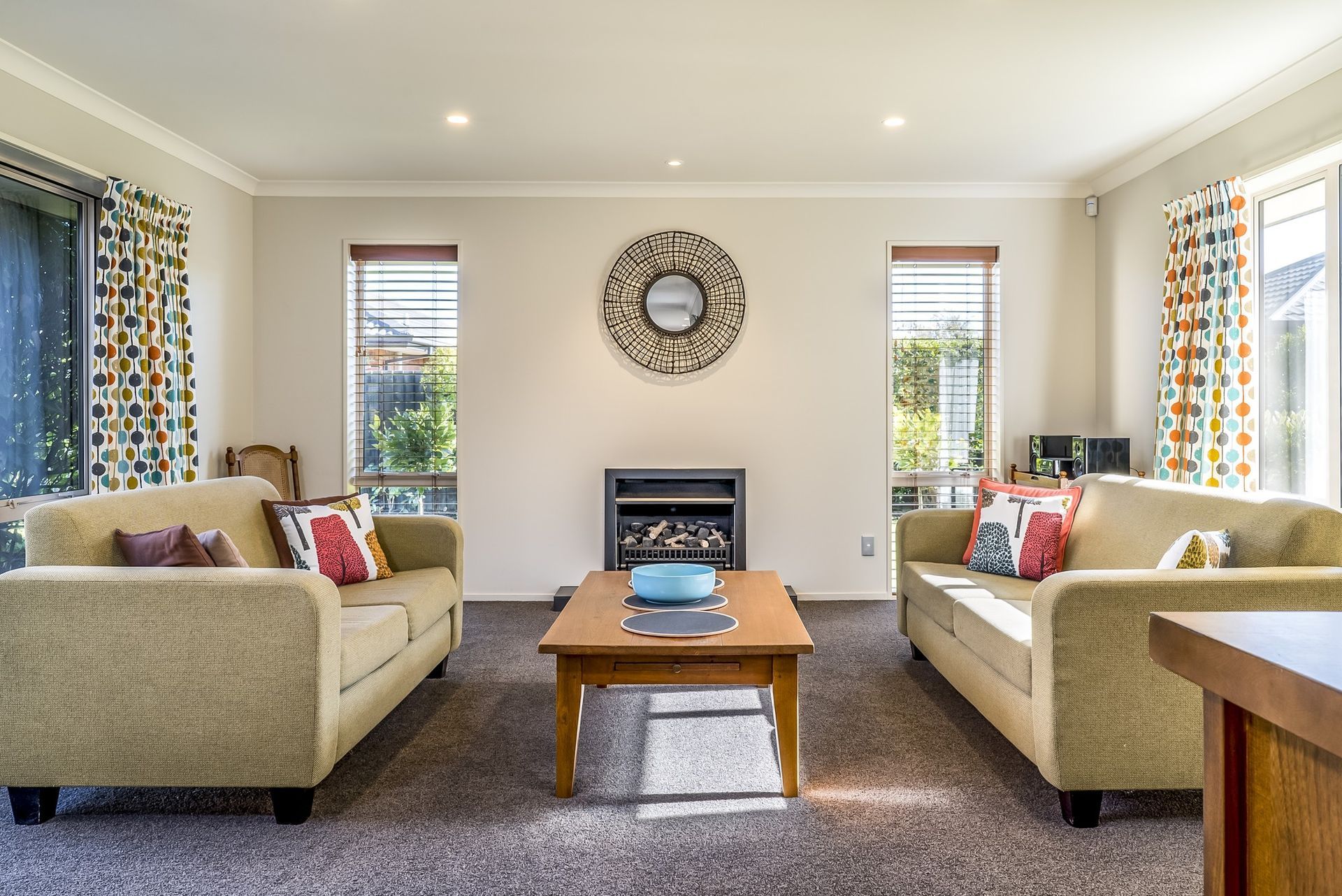 A living room with two couches , a coffee table and a fireplace.