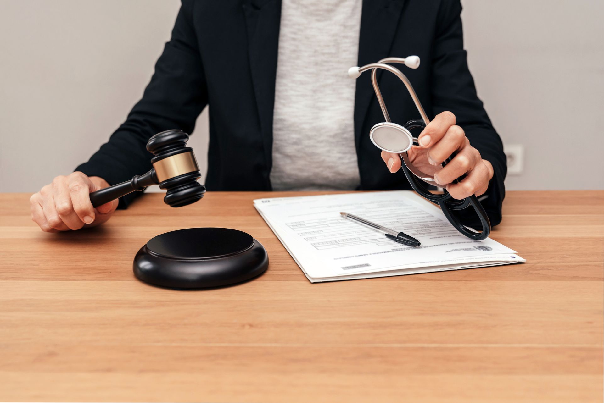 Gavel, stethoscope, and legal documents on a desk representing medical malpractice law.