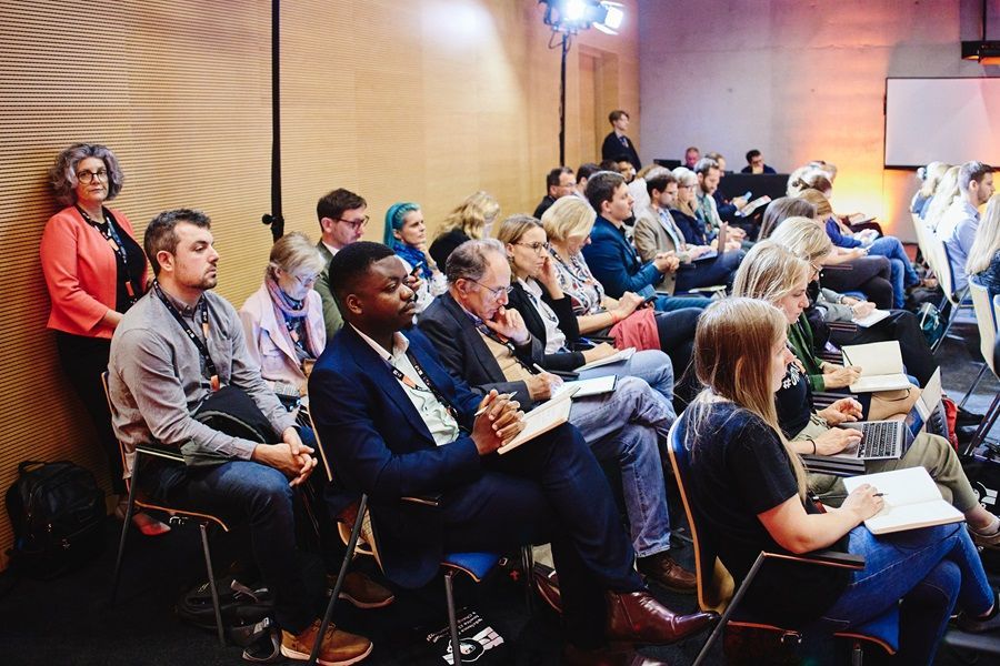 A group of people are sitting in chairs in a room.