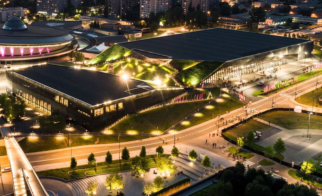 An aerial view of a large building in a city at night.