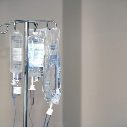 IV bags hanging on a metal stand in a hospital setting