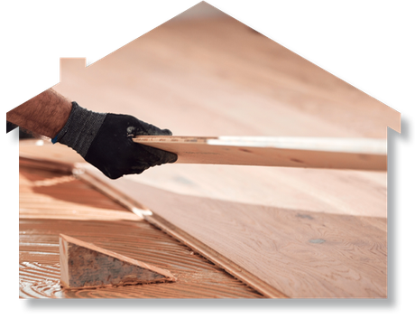 A person is holding a piece of wood in their hand.