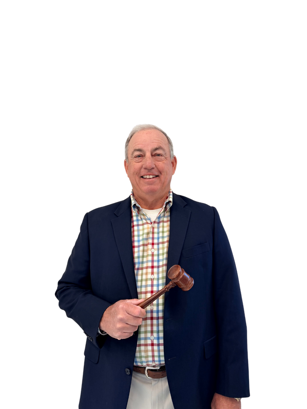 Man in suit pose with gavel, smiling.