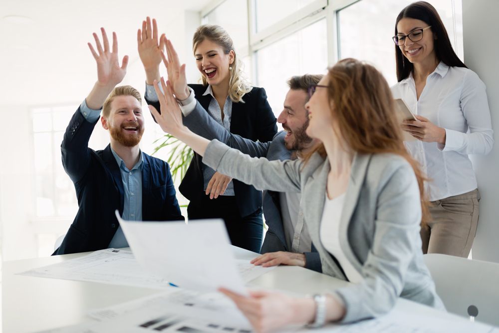 a group of people are giving each other a high five