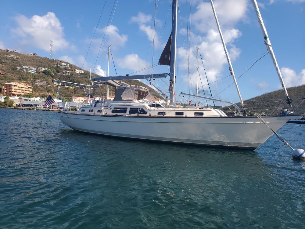 A sailboat is floating on top of a body of water.