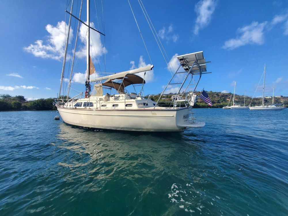 A sailboat is floating on top of a body of water.