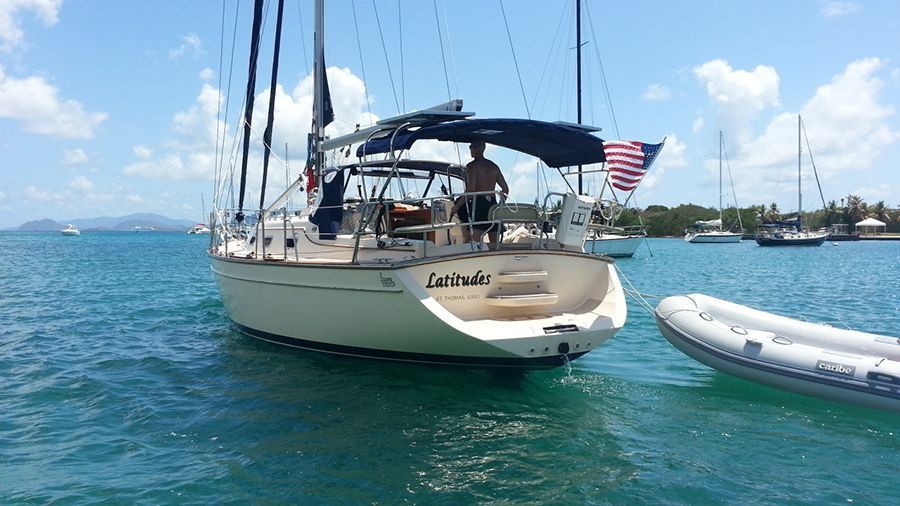 A sailboat is floating on top of a body of water