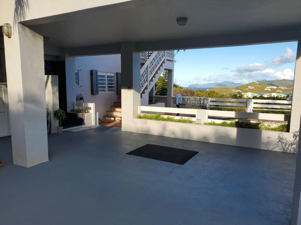 Covered lower deck at Villa Nathalie in St. Thomas with open views toward St. John and the Caribbean