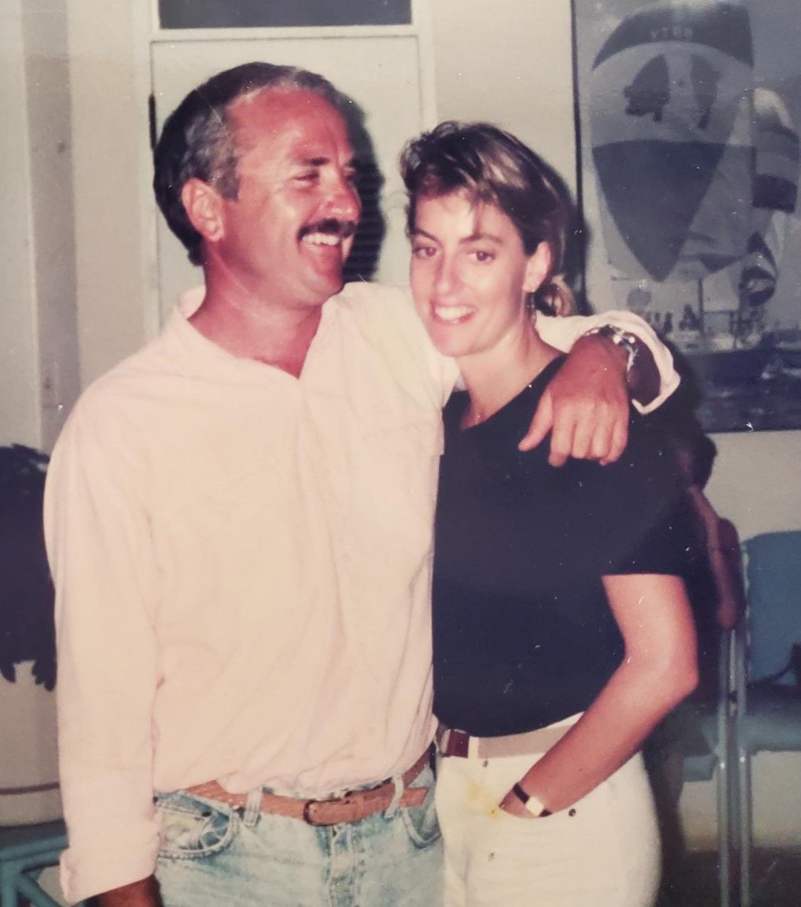 A man and woman are posing for a picture and the woman is wearing a black shirt