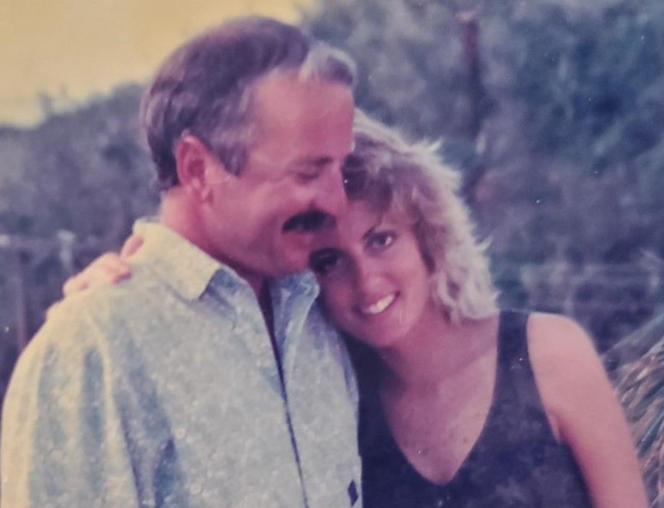 A man and a woman are posing for a picture together