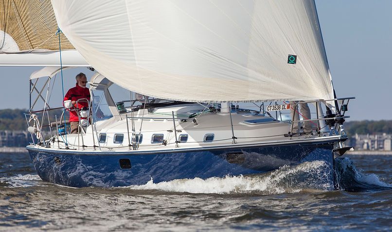 A sailboat is floating on top of a body of water.