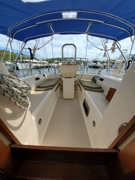 The inside of a boat with a blue canopy