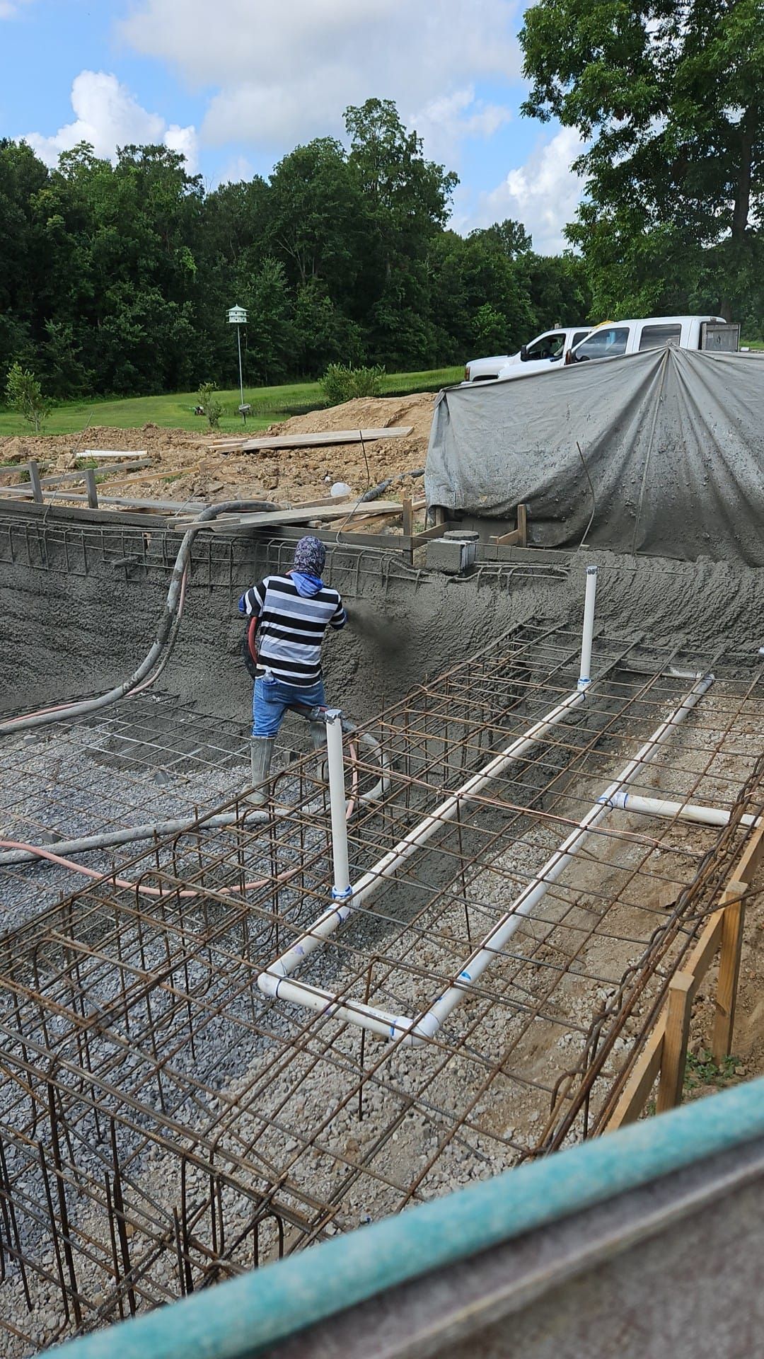 A concrete driveway is being built in front of a house.