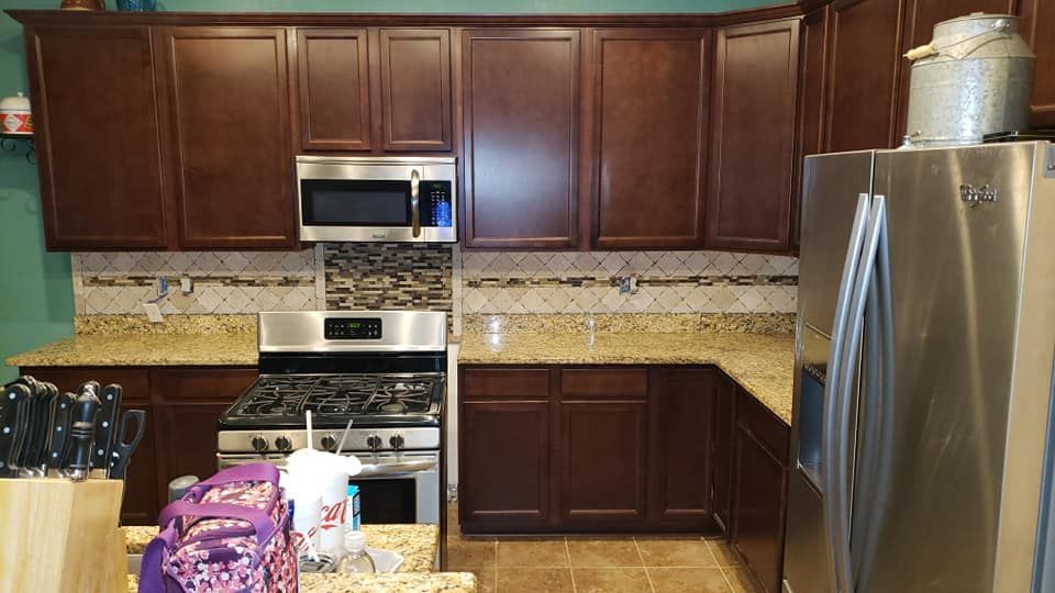 A kitchen with stainless steel appliances and wooden cabinets.