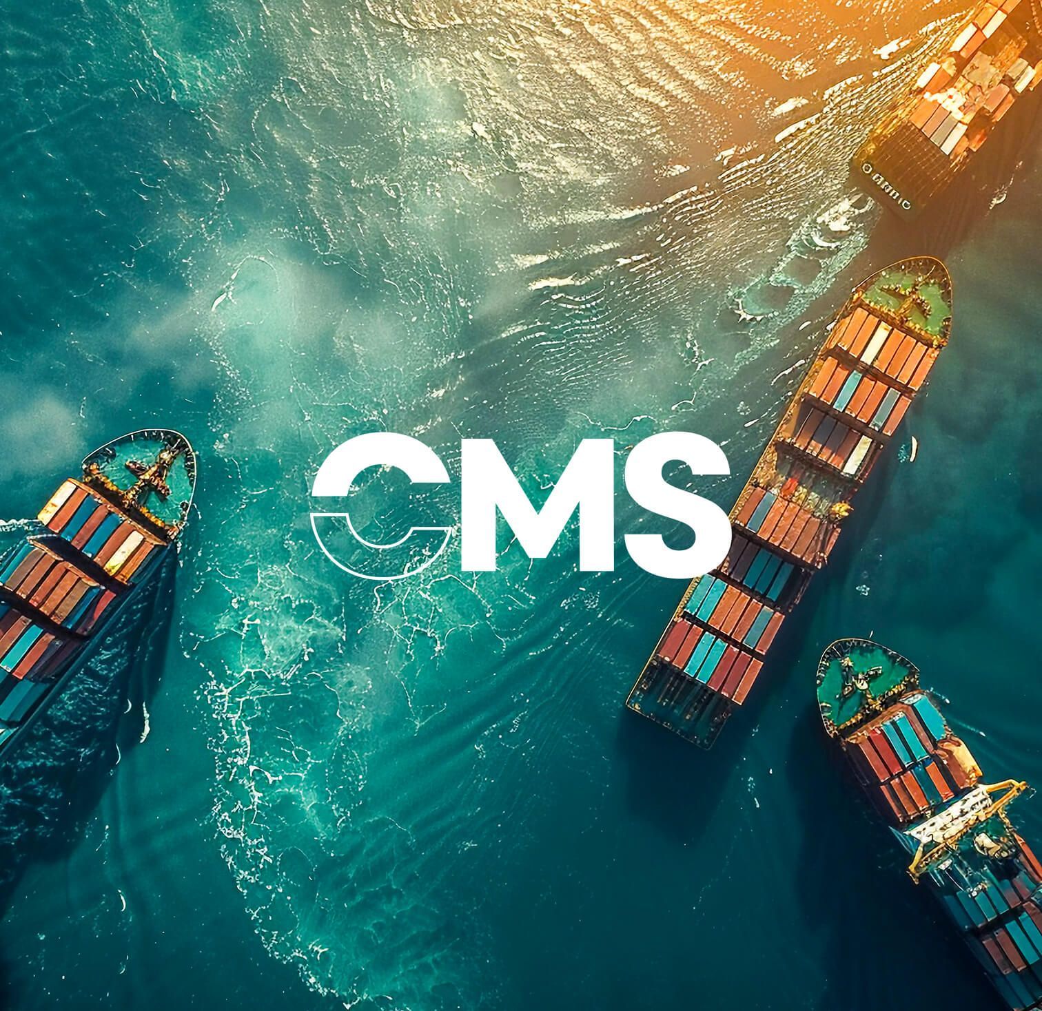 Cargo ships in teal water with white “CMS” text centered over the scene