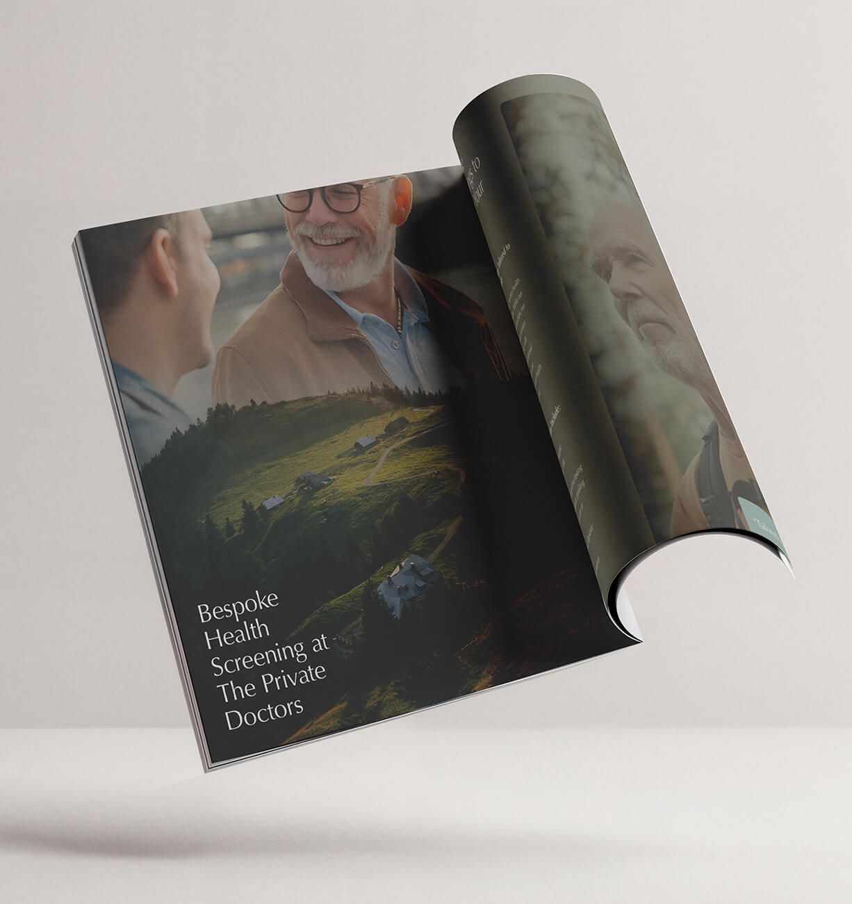 A glossy brochure or magazine partially rolled open, showing a landscape cover with people and text.