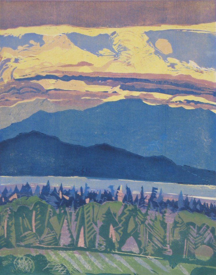 Mountains and trees under a sunset sky