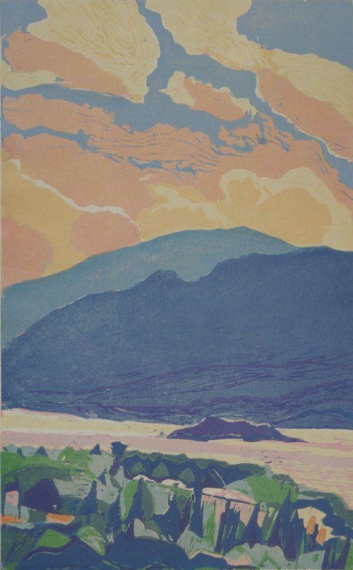 Mountains under a sky of pink and blue clouds