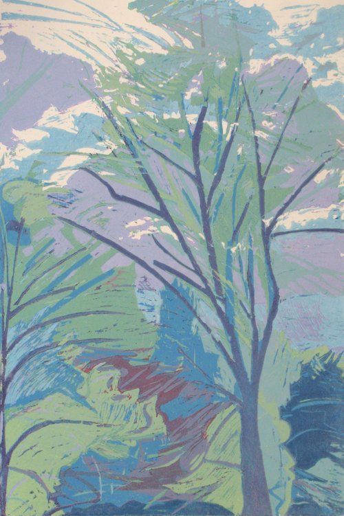 Tree silhouetted against a sky with pastel hues