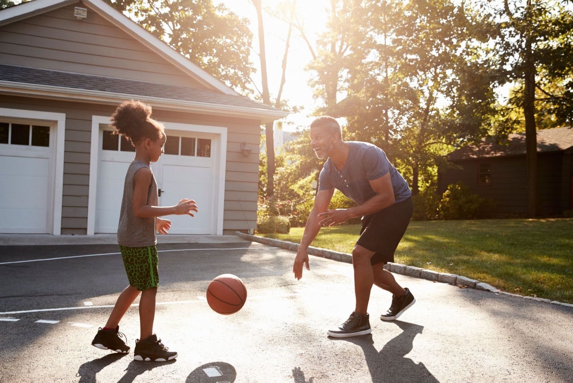 Family playing on concrete driveway