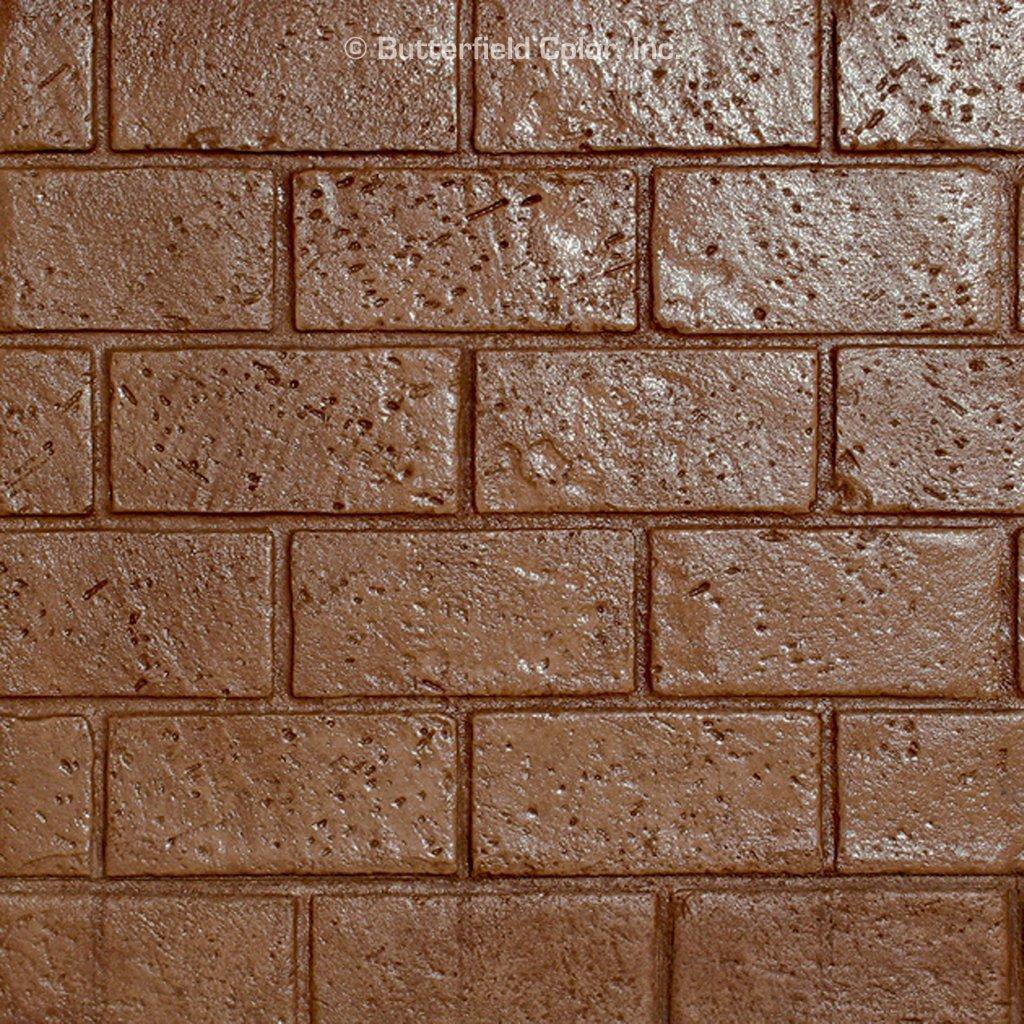 A close-up of a brown, weathered brick pattern with a textured, rustic finish.