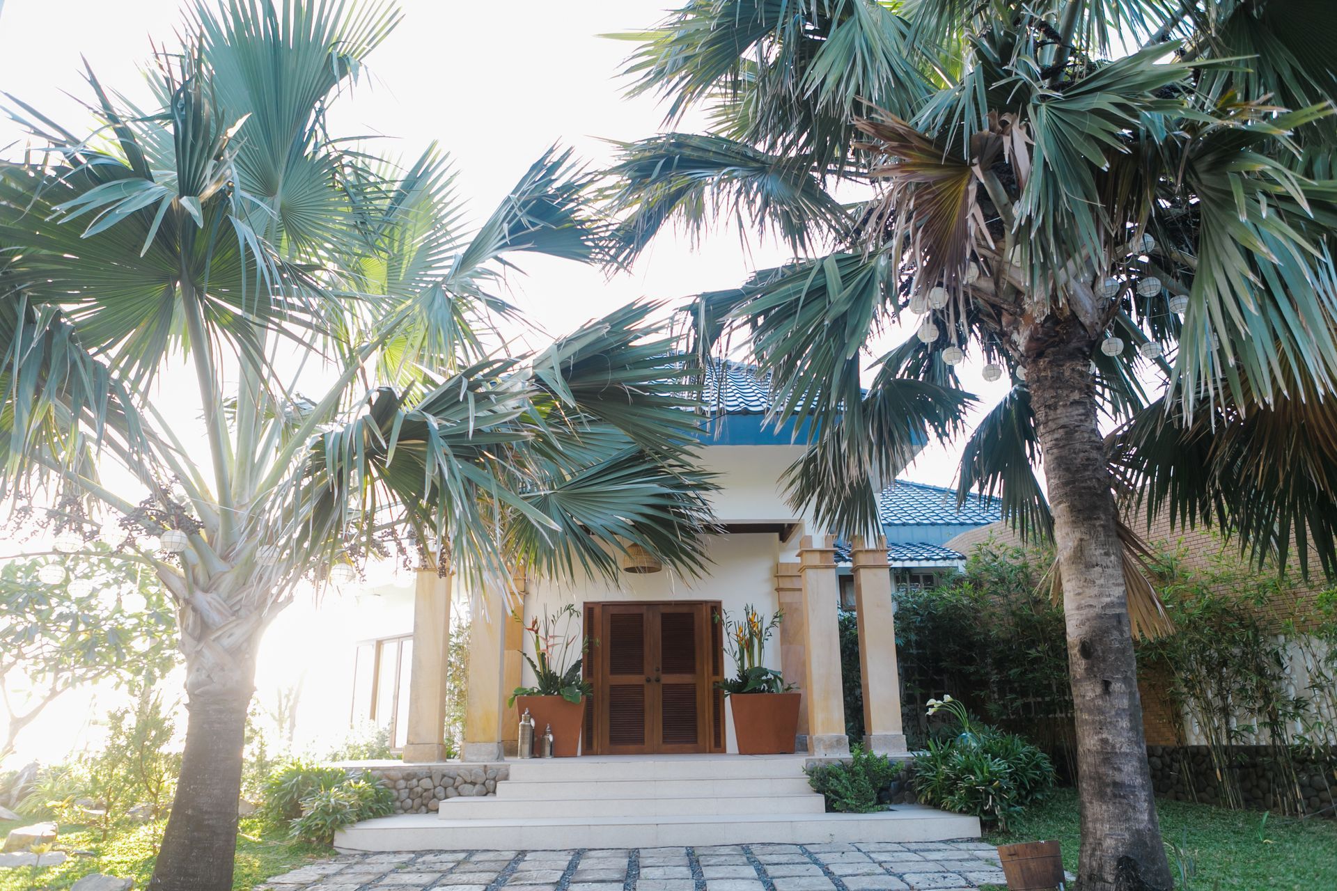 A house with palm trees in front of it