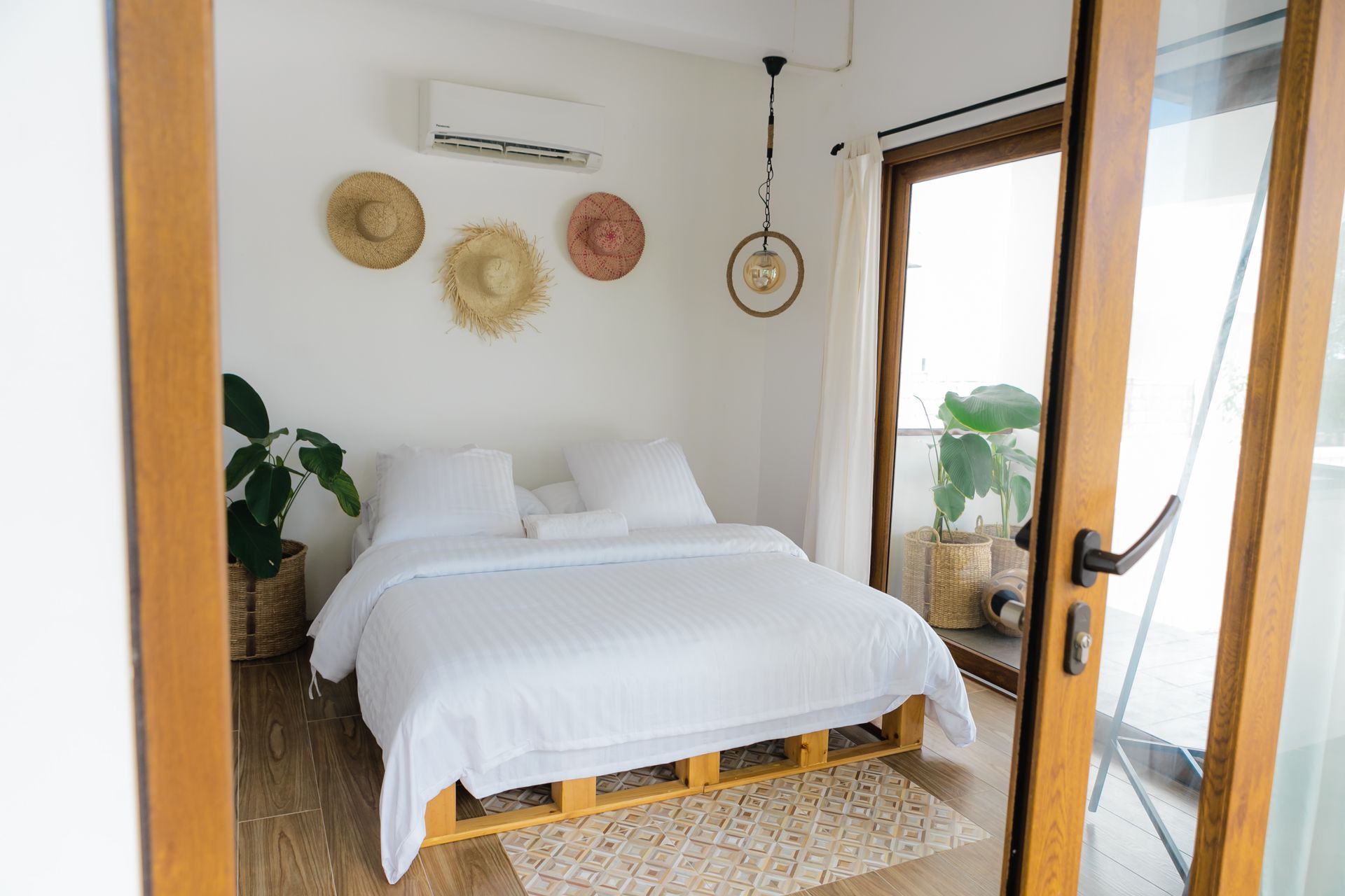 A bedroom with a bed and a sliding glass door.