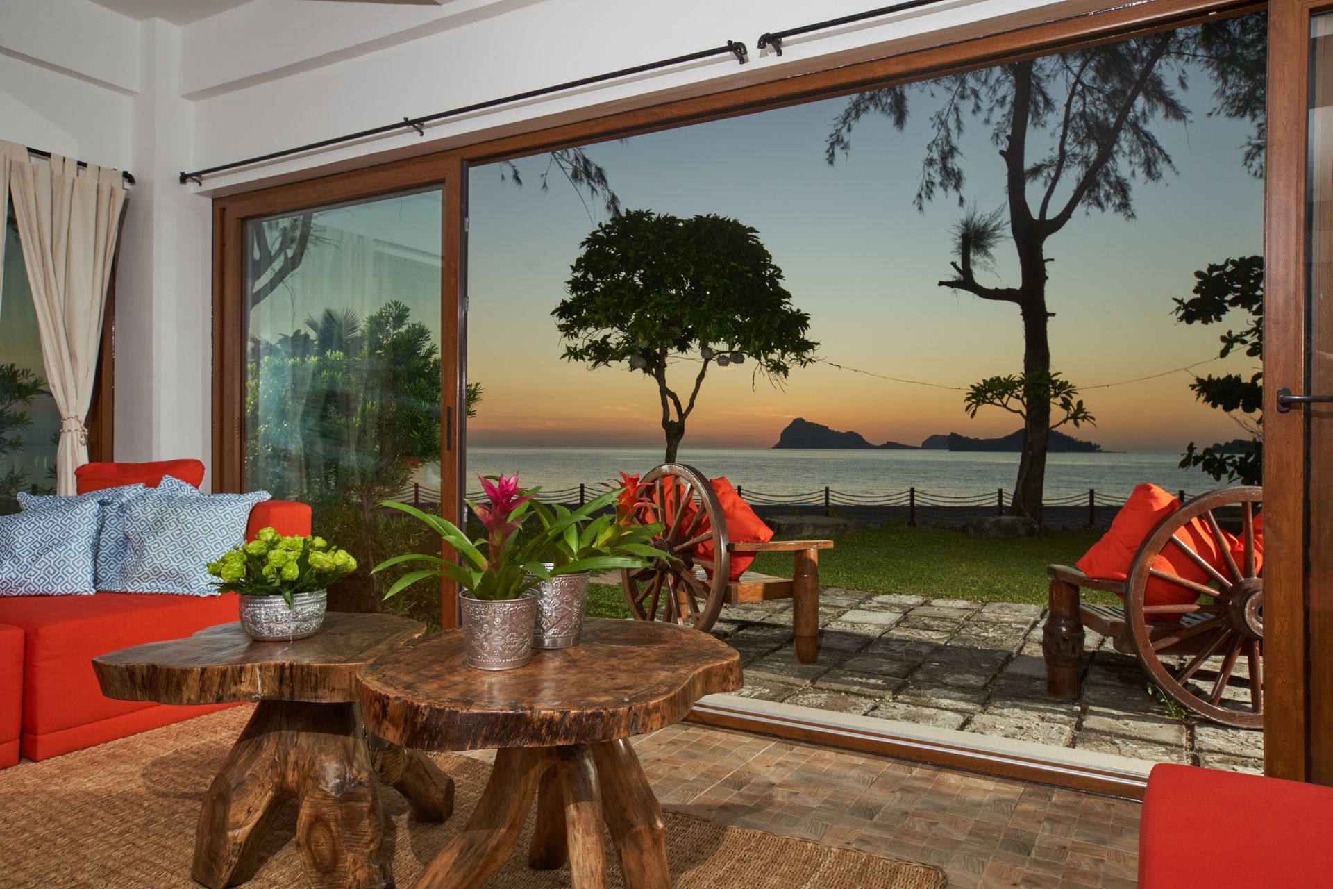 A living room with a view of the ocean and trees