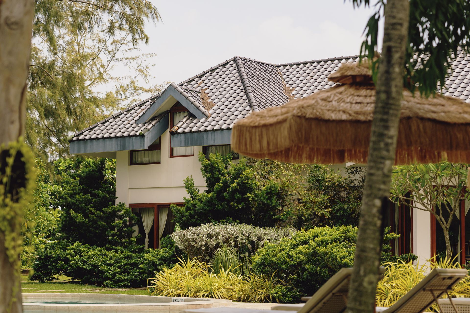 A house with a thatched umbrella in front of it