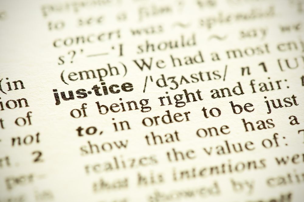 A close up of the word justice in a dictionary