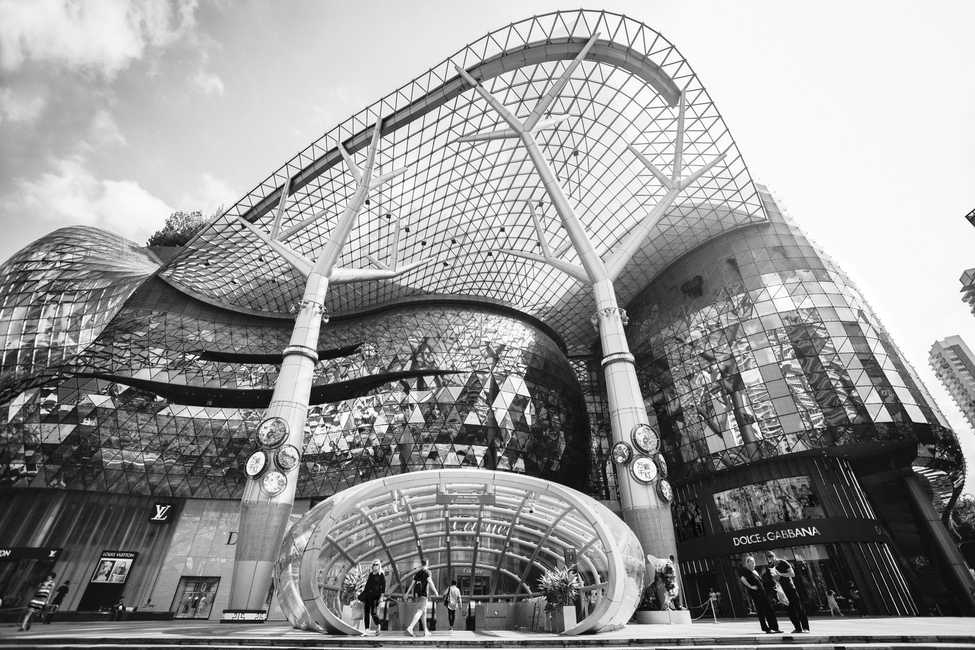 A black and white photo of a large building with a glass roof.